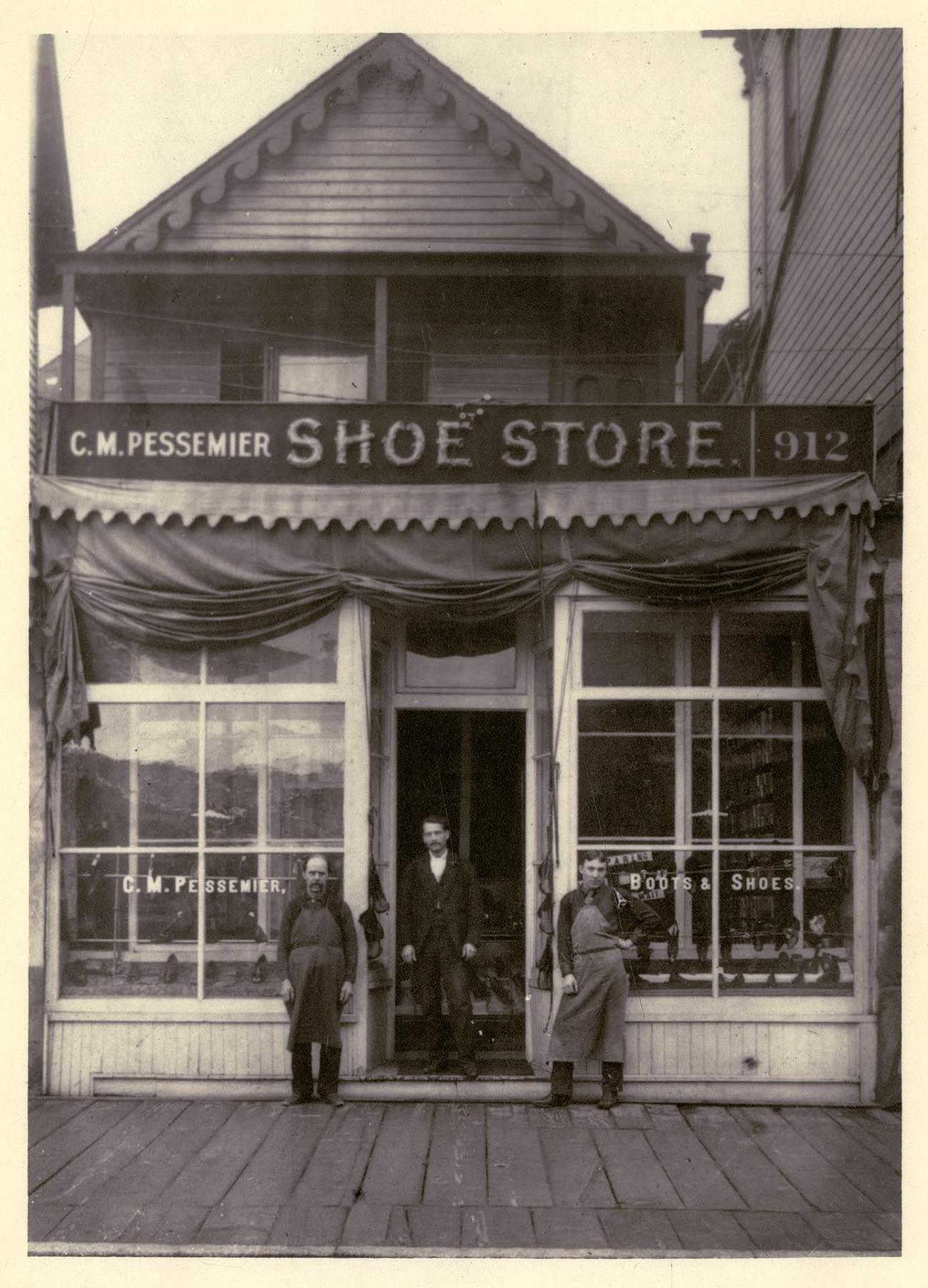 Image of C. M. Pessemier in doorway of his shoe store, Seattle, circa 1891